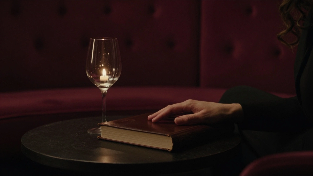 A candlelit lounge with a wine glass and open book, suggesting a quiet, intimate conversation just concluded.